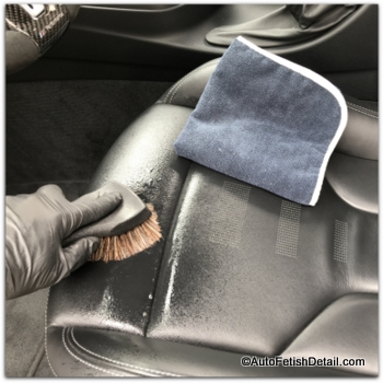 cleaning black car leather in BMW M4 with horse hair brush cleaning black car leather with horse hair brush