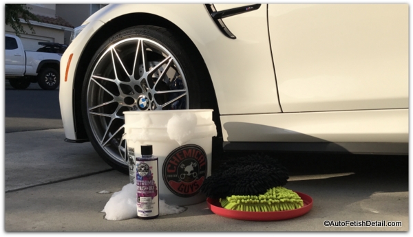 car wash kit sitting in front of white BMW M4 how to wash your car wash kit