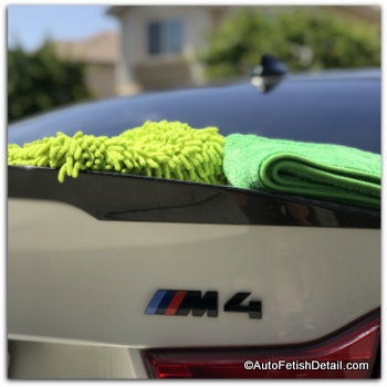 optimum no rinse car wash wash tools on back of white BMW M4 optimum no rinse car wash technique