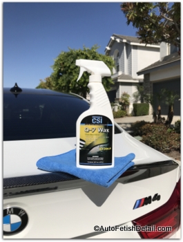 Q-7 spray wax sitting on deck lid of white, BMW M4 Q-7 car wax on BMW
