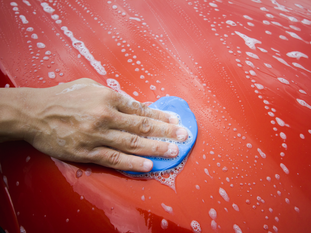 using the best clay bar on this red car to remove bonded contaminants using the best clay bar